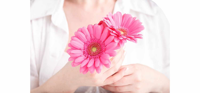 woman holding pink flowers