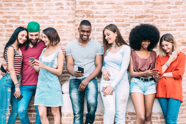Young group of people together on cell phones