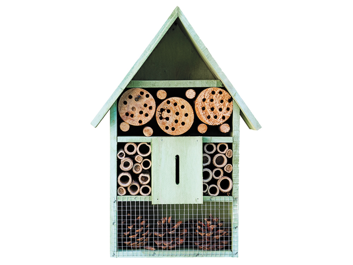 Pollinator house with small holes for faux hives for bees
