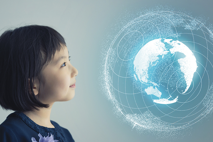 Child looking at projection of Earth