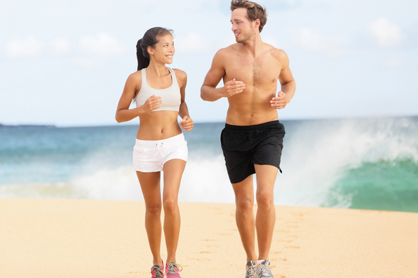 Couple power walking on the beach