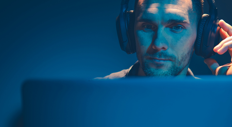 A man listening to music in his wireless headphones.