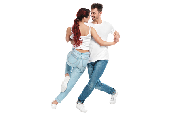 Couple dancing together wearing white tops, blue jeans and white sneakers