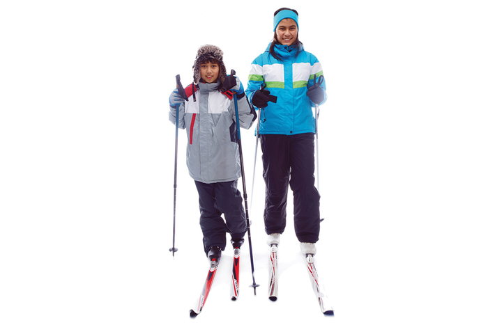Two kids cross-country skiing